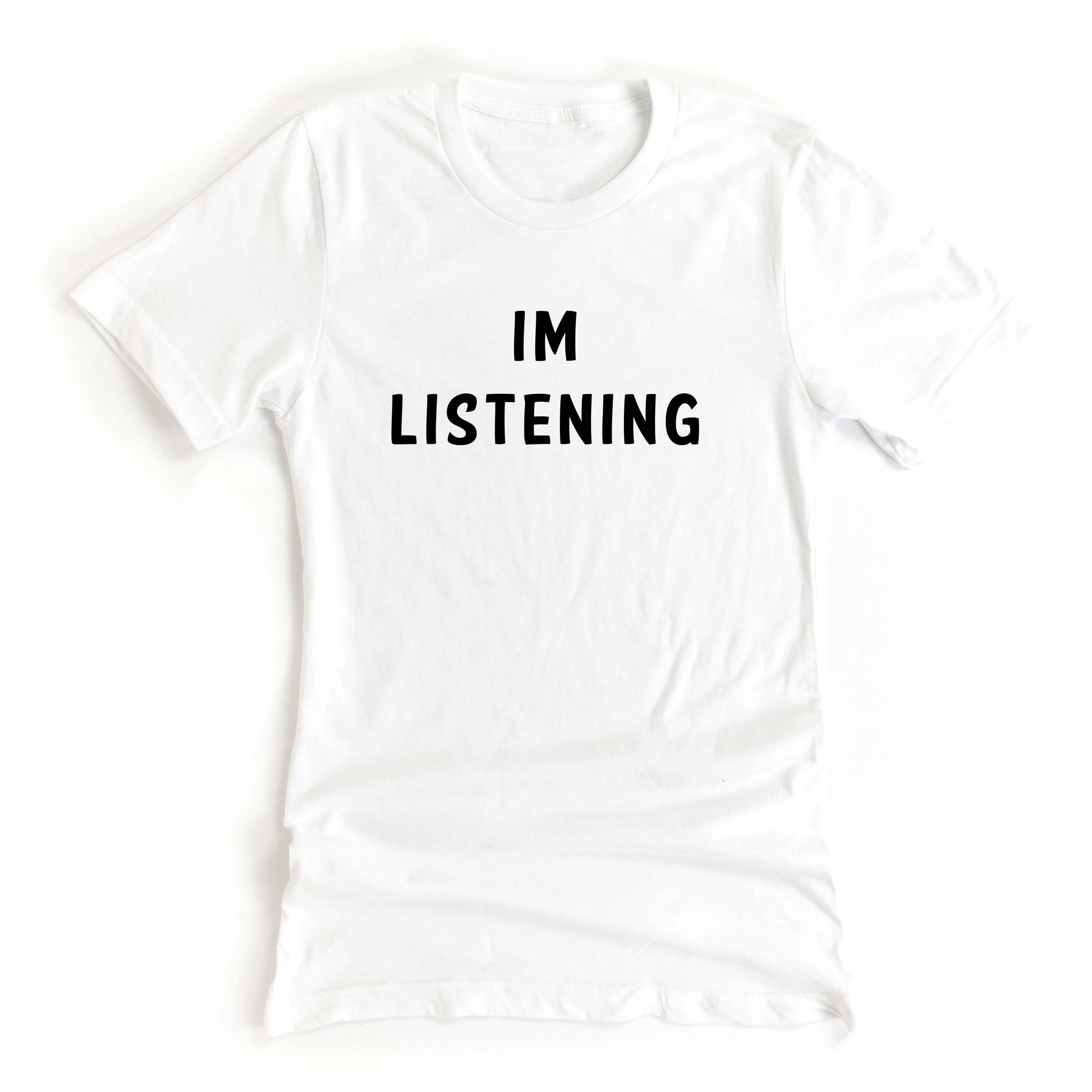 White tshirt on a white background with the text Im Listening in black ink 